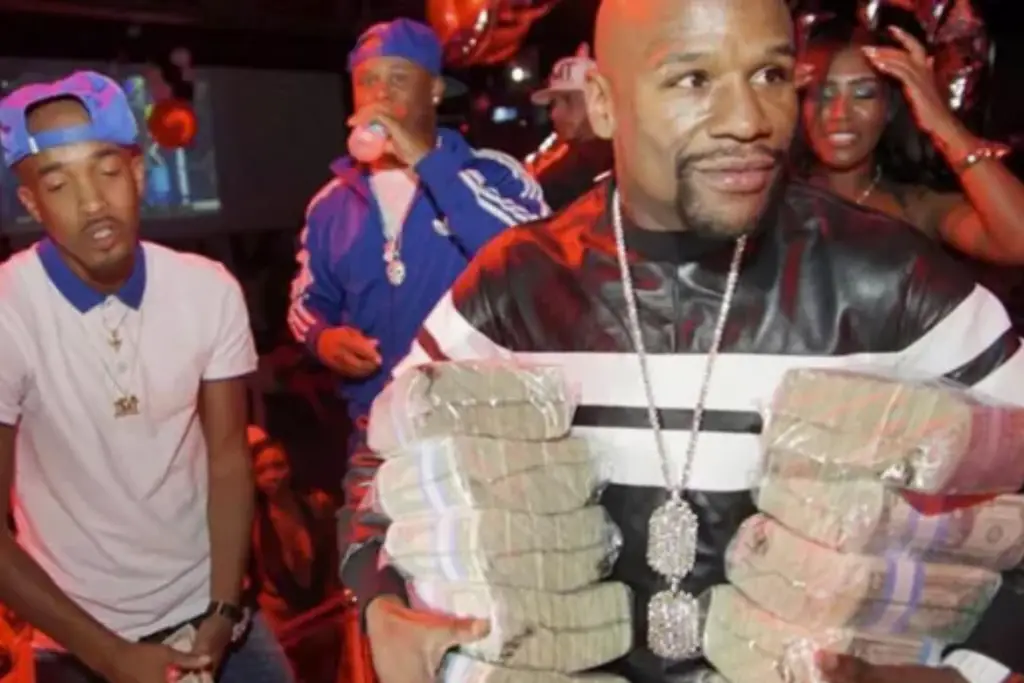 mayweather with stacks of money