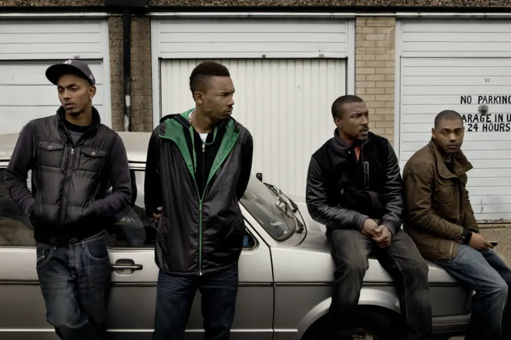 roadmen, sitting on a car.